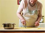 Elderly Italian woman making pasta by hand in kitchen, working with dough, Ontario, Canada