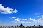 Blue sky with clouds and cityscape