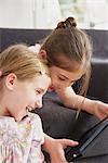 Two girls using digital tablet, Munich, Bavaria, Germany