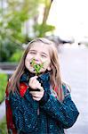 Little schoolgirl holding evergreen twig, Munich, Bavaria, Germany