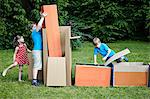 Children playing in cardboard boxes, Munich, Bavaria, Germany