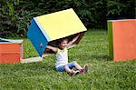 Girl playing with cardboard box, Munich, Bavaria, Germany