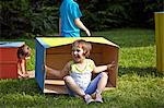 Children playing with cardboard boxes, Munich, Bavaria, Germany