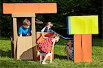 Children playing with cardboard boxes, Munich, Bavaria, Germany