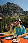 Mountain biker drinking a beer, Kleinwalsertal, Vorarlberg, Austria