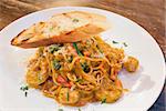 Seafood Spaghetti Pasta Cooked in Tomato Cream Sauce with Prawns Scallops White Fish Basil Bell Peppers and Bread