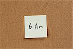 6am reminder note on cork board, handwritten