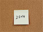 2014 reminder note on cork board, handwritten