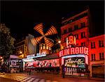 PARIS - JULY 1: The Moulin Rouge by night, on July 1, 2013 in Paris, France. Moulin Rouge is a famous cabaret built in 1889, locating in the Paris red-light district of Pigalle