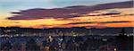 Colorful Sunset Over Portland Oregon Cityscape with City Lights and View of West Hills Panorama