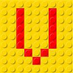 Red letter V in yellow plastic construction kit. Typeface  sample.