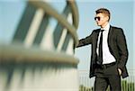 Portrait of businessman standing by railing and looking at view, Germany