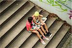 Girls Sitting on Steps with Skateboard, Mannheim, Baden-Wurttemberg, Germany