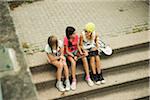 Girls Sitting on Steps with Tablet Computers and Skateboard, Mannheim, Baden-Wurttemberg, Germany