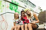 Girls Sitting on Steps with Tablet Computers, Mannheim, Baden-Wurttemberg, Germany