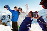 Girl photographing siblings, Les Arcs, Haute-Savoie, France