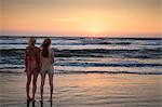 Mother and daughter looking at sunset