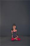 Woman in yoga pose on grey background