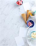 Still life with bowls of ice cream and cones