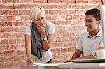 Two colleagues talking at desk