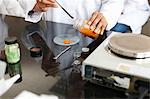 Female technician weighing chemicals in laboratory