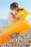 Boy hugging duck shaped float