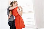 Young couple in front of window