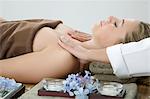 Woman having shoulder massage at spa