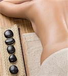 Woman having hot stone therapy