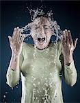 Young woman splashing water on face