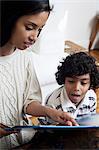 Mother and son looking at book