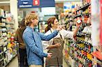 Female shop assistant guiding male customer