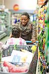 Female shopper with daughter in trolley