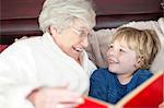 Grandmother and grandson reading in bed