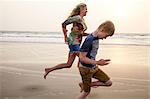 Mother and son running on beach
