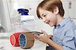 Boy playing with office equipment