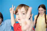 Portrait of boy making peace sign