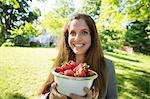 On The Farm. A Woman Carrying A Bowl Of Organic Fresh Picked Strawberries.