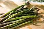 On The Farm. A Chopping Board And Sharp Kitchen Knife. A Bunch Of Freshly Picked Organic Asparagus.