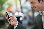 Summer. A Young Man In A Grey Suit. Using A Smart Phone.