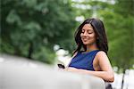 Business People. A Woman With Long Black Hair Wearing A Blue Dress.