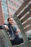 Business People. A Man In A Suit, Sitting On A Bench.