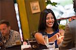 Business People. Two People Seated At A Table Holding Hands. A Man In The Background.