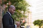 Business People. A Man In A Suit Checking His Phone.