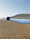 The Landscape Of The Black Rock Desert In Nevada. A Bottle Of Water. Filtered Mineral Water. Sideways. The Water Level Matching The Horizon.