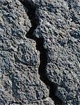 A Lava Field, With Black Solidified Rock Surface, With Fissures.