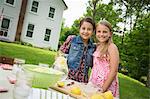 A Summer Family Gathering At A Farm. Two Children Standing Side By Side. Making Homemade Lemonade.