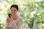 Summer. Business People. A Woman Checking Her Smart Phone For Messages.