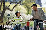 Bicycling And Having Fun. A Father And Son Side By Side.