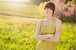 Young Woman In Grassy Field In Spring.